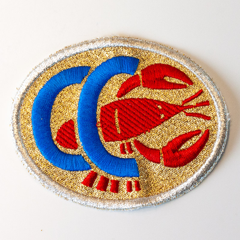 Stoffwappen mit Silberkordel